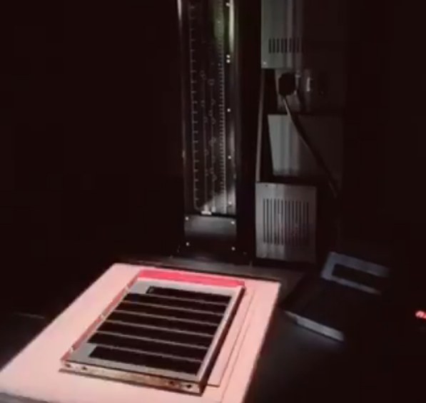 Contact printing frame under the enlarger in the darkroom